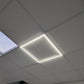 Linear frame light installed and lit in a real suspended ceiling