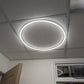 Round Halo light installed and lit in a real office ceiling grid