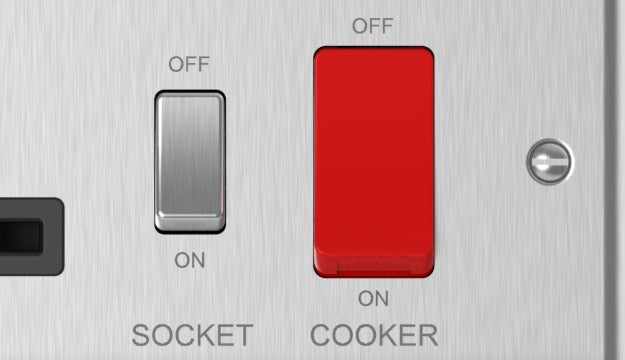 Close-up of brushed steel cooker control unit socket switch and cooker switch