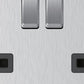 Close-up of brushed steel 2 gang socket outlets and switches