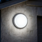 AIO bulkhead installed on garage wall in the evening, lit