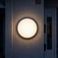 AIO bulkhead installed beside front door at night, lit