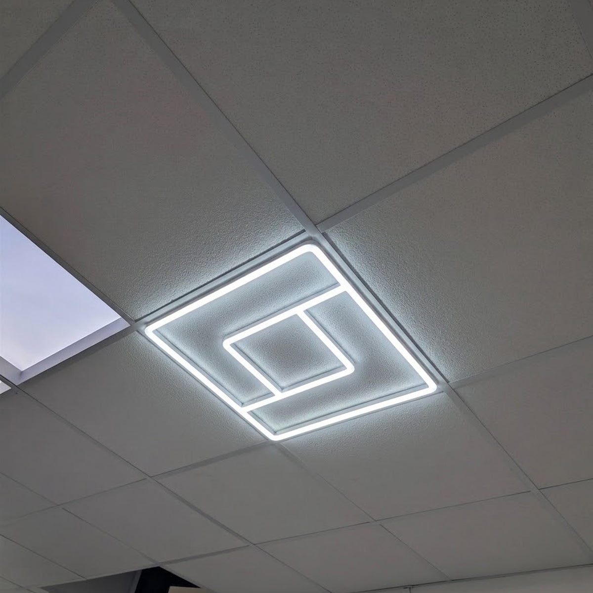 Greek Key LED Linear Frame Light installed and lit in a real ceiling grid