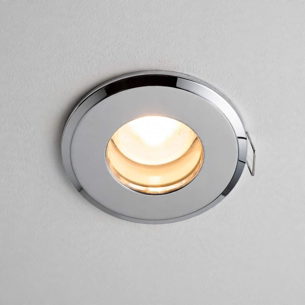 IP65 fire rated GU10 downlight installed in bathroom ceiling, lit