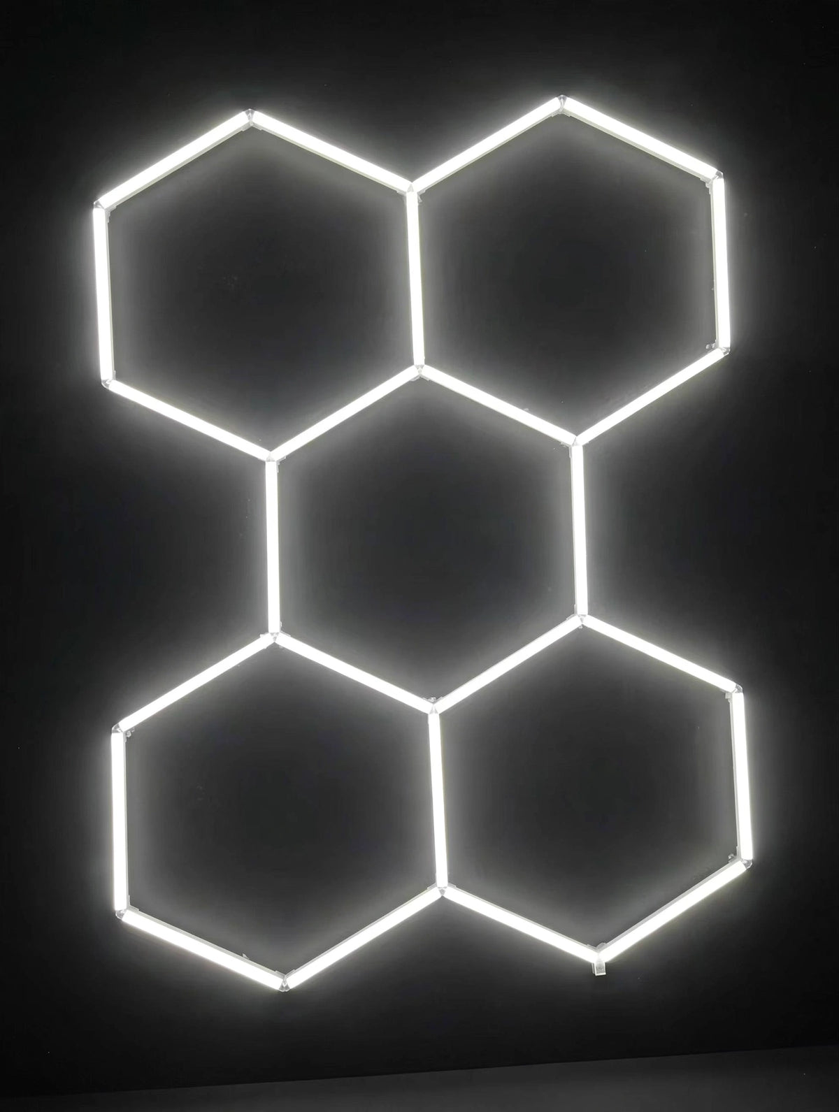 5-grid hexagon LED frame glowing on studio wall