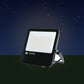 LED Dual Voltage Floodlight in a garden at night – lifestyle image, product unchanged
