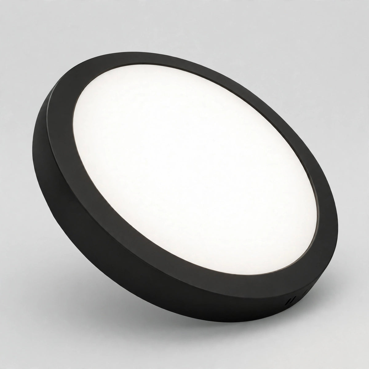 Black round LED panel light glowing in 4000K cool white