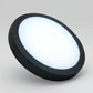 Black round LED panel light glowing in 6500K daylight