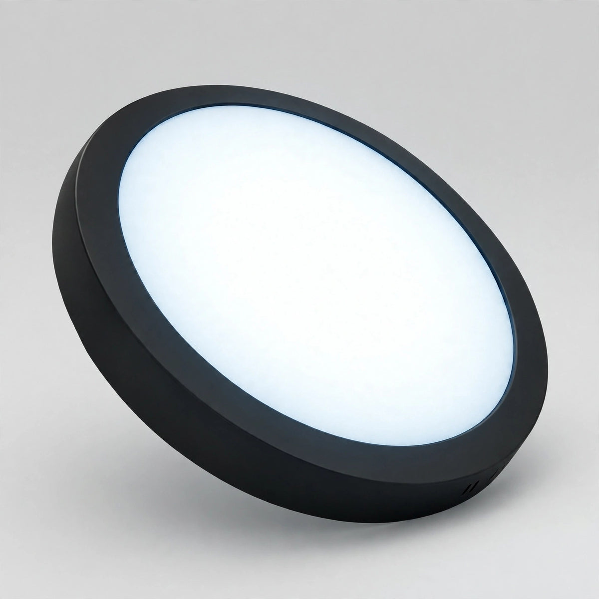 Black round LED panel light glowing in 6500K daylight
