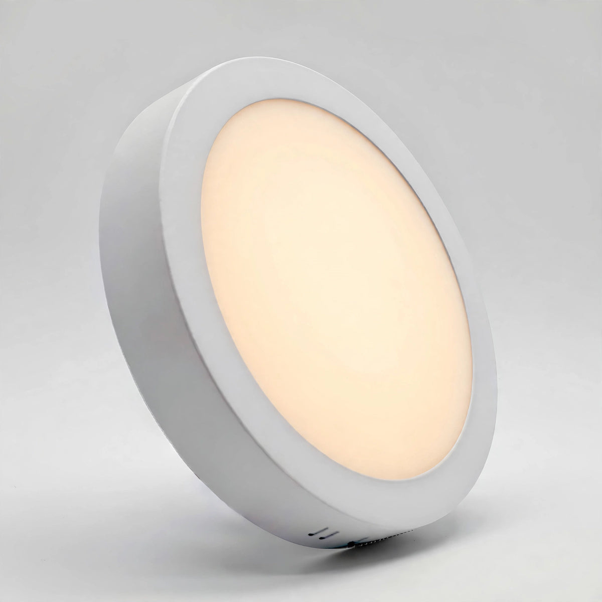 Round LED panel light switched on with warm white glow