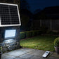 Solar LED floodlight lighting a garden at night